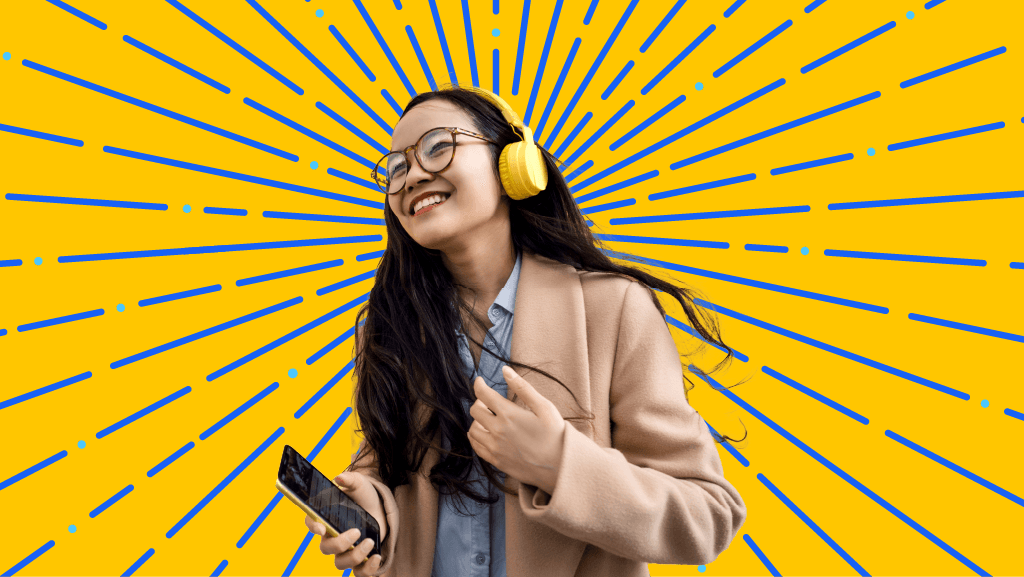 a woman is wearing headphones and holding a cell phone